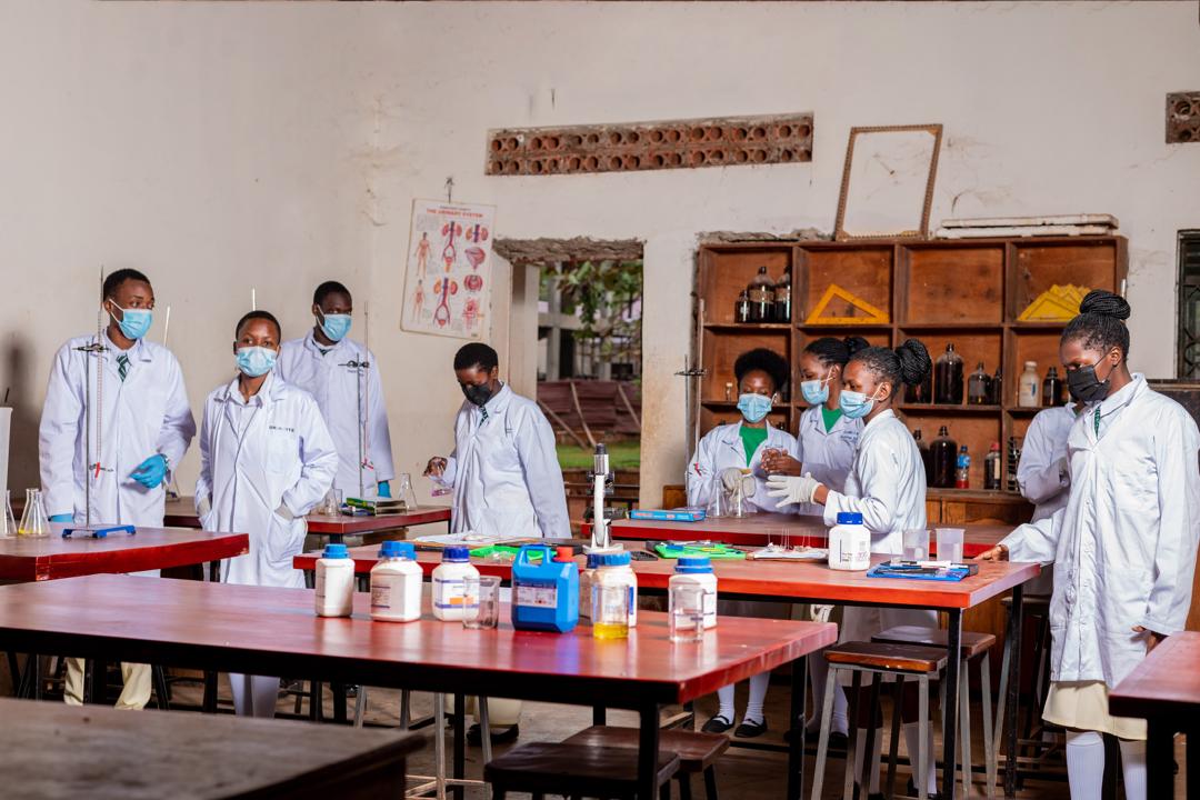 Bright Future students in lab coats during a science practical