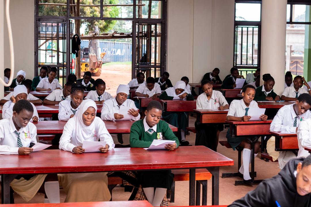 Bright Future Secondary School students studying together in a classroom in Bwebajja